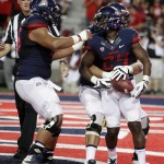 Arizona running back Terris Jones-Grigsby (24) celebrates with teammates after scoring a touchdown against UNLV during the second half of an NCAA college football game, Friday, Aug. 29, 2014, in Tucson, Ariz. (AP Photo/Rick Scuteri)
