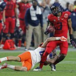 Arizona cornerback Cam Denson (3) is hit by Boise State wide receiver Thomas Sperbeck after intercepting a pass intended for Sperbeck during the first half of the Fiesta Bowl NCAA college football game, Wednesday, Dec. 31, 2014, in Glendale, Ariz. (AP Photo/Rick Scuteri)