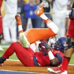 Arizona running back Nick Wilson lands in the end zone for a touchdown against Boise State during the first half of the Fiesta Bowl NCAA college football game, Wednesday, Dec. 31, 2014, in Glendale, Ariz. (AP Photo/Ross D. Franklin)