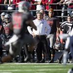 Washington State coach Mike Leach, center, watches as wide receiver River Cracraft (21) catches a Connor Halliday pass against Arizona during the first quarter of an NCAA college football game Saturday, Oct. 25, 2014, in Pullman, Wash. (AP Photo/Dean Hare)