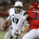 Nevada quarterback Cody Fajardo (17) runs for a first down in front of Arizona safety Jared Tevis (38) during the first half of an NCAA college football game, Saturday, Sept. 13, 2014, in Tucson, Ariz. (AP Photo/Rick Scuteri)