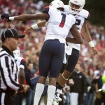 Arizona wide receiver Cayleb Jones (1) and quarterback Anu Solomon (12) celebrate after connecting for a touchdown against Washington State during the second quarter of an NCAA college football game Saturday, Oct. 25, 2014, in Pullman, Wash. (AP Photo/Dean Hare)