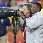 Former MLB baseball player Ken Griffey Jr. shoots pictures from the sidelines during the first half of the Fiesta Bowl NCAA college football game between Arizona and Boise State, Wednesday, Dec. 31, 2014, in Glendale, Ariz. (AP Photo/Ross D. Franklin)