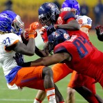 Boise State running back Jay Ajayi (27) is hit by Arizona defensive lineman Reggie Gilbert during the first half of the Fiesta Bowl NCAA college football game, Wednesday, Dec. 31, 2014, in Glendale, Ariz. (AP Photo/Ross D. Franklin)