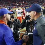 Arizona head coach Rich Rodriguez, right, shakes hands with Boise State head coach Bryan Harsin, left, after the Fiesta Bowl NCAA college football game, Wednesday, Dec. 31, 2014, in Glendale, Ariz. Boise State won 38-30. (AP Photo/Ross D. Franklin)