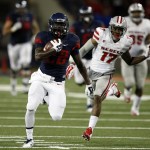 Arizona running back Nick Wilson (28) scores a touchdown against UNLV during the second half of an NCAA college football game, Friday, Aug. 29, 2014, in Tucson, Ariz. (AP Photo/Rick Scuteri)