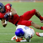 Arizona running back Trey Griffey (5) is hit by Boise State cornerback Cleshawn Page (3) during the first half of the Fiesta Bowl NCAA college football game, Wednesday, Dec. 31, 2014, in Glendale, Ariz. (AP Photo/Ross D. Franklin)