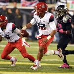 Arizona quarterback Anu Solomon (12) runs with the ball during the second quarter of an NCAA college football game against Oregon on Thursday, Oct. 2, 2014, in Eugene, Ore. (AP Photo/Steve Dykes)