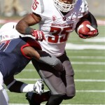 Washington State's Marcus Mason (35) is dragged down by Arizona's William Parks (11) in the first half of an NCAA college football game on Saturday, Nov. 16, 2013, in Tucson, Ariz. (AP Photo/John MIller)