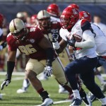 Arizona running back Ka'Deem Carey (25) rushes up field asile Boston College defensive lineman Kaleb Ramsey (96) pursues during the first half of the AdvoCare V100 Bowl NCAA college football game, Tuesday, Dec. 31, 2013, at Independence Stadium in Shreveport, La. (AP Photo/Rogelio V. Solis)