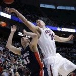 Arizona's Kaleb Tarczewski (35) and Belmont's Brandon Baker (45) vie after a rebound during the first half in a second-round game in the NCAA college basketball tournament in Salt Lake City Thursday, March 21, 2013. (AP Photo/Rick Bowmer)