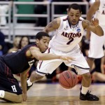 Harvard's Siyani Chambers, left, reaches for a loose ball in front of Arizona's Mark Lyons (2) during the first half in a third-round game in the NCAA men's college basketball tournament in Salt Lake City, Saturday, March 23, 2013. (AP Photo/Rick Bowmer)
