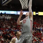 Washington State's Brock Motum (12) dunks the ball over Arizona's Brandon Ashley during the first half of an NCAA college basketball game at McKale Center in Tucson, Ariz., Saturday, Feb. 23, 2013. (AP Photo/Wily Low)
