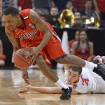 Arizona's Mark Lyons, left, breaks clear of Ohio State's Aaron Craft during the second half of a West Regional semifinal in the NCAA men's college basketball tournament, Thursday, March 28, 2013, in Los Angeles. Ohio State won 73-70. (AP Photo/Mark J. Terrill)