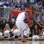 Arizona's Mark Lyons tumbles in front of Ohio State's Deshaun Thomas during the first half of a West Regional semifinal in the NCAA men's college basketball tournament, Thursday, March 28, 2013, in Los Angeles. (AP Photo/Mark J. Terrill)