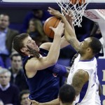 Arizona's Kaleb Tarczewski, left, battles for a rebound against Washington's Desmond Simmons, right, in the first half of an NCAA college basketball game, Thursday, Jan. 31, 2013, in Seattle. (AP Photo/Ted S. Warren)