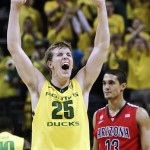 Oregon's E.J. Singler (25) celebrates as Arizona's Nick Johnson (13) walks downcourt after a turnover went to Oregon late in the second half of their NCAA college basketball game, Thursday, Jan. 10, 2013, in Eugene, Ore. Oregon won 70-66. (AP Photo/Chris Pietsch)