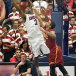 Arizona's Mark Lyons (2) shoots over the reach of Southern California's Jio Fontan (1) during the first half of an NCAA college basketball game at McKale Center in Tucson, Ariz., Saturday, Jan. 26, 2013. (AP Photo/Wily Low)
