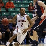 Arizona's Mark Lyons, left, drives around Belmont's Trevor Noack during the first half of a second-round game in the NCAA college basketball tournament in Salt Lake City Thursday, March 21, 2013. (AP Photo/George Frey)