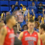  A fan holds up a photo of UCLA guard Norman Powell as members of the Arizona team prepare to play an NCAA college basketball game on Thursday, Jan. 9, 2014, in Los Angeles. (AP Photo/Mark J. Terrill)