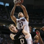 Arizona's Brandon Ashley, center, goes over the back of Harvard's Laurent Rivard during the second half during a third-round game in the NCAA men's college basketball tournament in Salt Lake City on Saturday, March 23, 2013. Arizona defeated Harvard 74-51. (AP Photo/George Frey)
