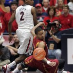 Southern California's Jio Fontan (1) falls and loses control of the ball in front of Arizona's Mark Lyons (2) during the first half of an NCAA basketball game at McKale Center in Tucson, Ariz., Jan. 26, 2013. (AP Photo/John Miller)
