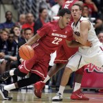  Washington States' Royce Woolridge (22) drives pass the pressing defense of Arizona's T.J. McConnell, right, in the first half of an NCAA college basketball game on Thursday, Jan. 2, 2014, in Tucson, Ariz. (AP Photo/John MIller)