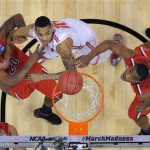 Ohio State's LaQuinton Ross, center, watches his shot drop in for a basket, between Arizona defenders Jordin Mayes, left, and Kevin Parrom during the first half of a West Regional semifinal in the NCAA men's college basketball tournament, Thursday, March 28, 2013, in Los Angeles. (AP Photo/Mark J. Terrill)