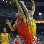 Arizona forward Brandon Ashley, left, puts up a shot as Southern California forward Strahinja Gavrilovic defends during the first half of an NCAA college basketball game, Sunday, Jan. 12, 2014, in Los Angeles. (AP Photo/Mark J. Terrill)