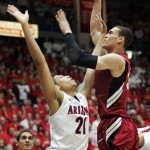 Stanford's Dwight Powell, right, shoots over Arizona's Brandon Ashley (21) during the second half of an NCAA college basketball game at McKale Center in Tucson, Ariz.,Wednesday, Feb. 6, 2013. Arizona won 73-66. (AP Photo/John Miller)