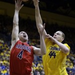  Arizona guard T.J. McConnell, left, shoots over California center Kameron Rooks during the first half on an NCAA college basketball game on Saturday, Feb. 1, 2014, in Berkeley, Calif. (AP Photo/Marcio Jose Sanchez)