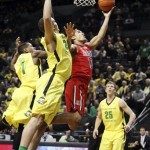 Arizona's Nick Johnson, center, drives past Oregon's Dominic Artis, left, Waverly Austin and E.J. Singer, right, during the first half of their NCAA college basketball game, Thursday, Jan. 10, 2013, in Eugene, Ore. (AP Photo/Chris Pietsch)