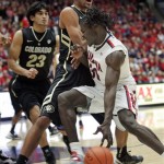 Arizona's Angelo Chol (30) drives against Colorado's Josh Scott, left, during the first half of an NCAA college basketball game at McKale Center in Tucson, Ariz., Thursday, Jan 3, 2013. (AP Photo/John Miller)