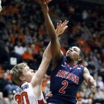 Arizona guard Mark Lyons, right, drives to the basket against Oregon State forward Olaf Schaftenaar during the first half of an NCAA college basketball game in Corvallis, Ore., Saturday, Jan. 12, 2013. (AP Photo/Don Ryan)
