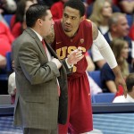 Southern California's interim head coach Bob Cantu, left, talks to his player, Ari Steward (5) on the sidelines during the second half against Arizona of an NCAA basketball game at McKale Center in Tucson, Ariz., Saturday, Jan. 26, 2013. (AP Photo/John Miller)

