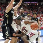 Arizona's Soloman Hill (44) tries to drive against Colorado's Shane Harris-Tunks (15) and Xavier Johnson, rear, during the first half of an NCAA college basketball game at McKale Center in Tucson, Ariz., Thursday, Jan 3, 2013. (AP Photo/John Miller)