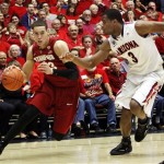 Stanford's Dwight Powell (33) drives to the basket around Arizona's Kevin Parrom (3) during the first half of an NCAA college basketball game at McKale Center in Tucson, Ariz., Wednesday, Feb. 6, 2013. (AP Photo/Wily Low)