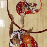 Arizona's Nick Johnson, bottom, grabs a rebound next to Stanford's Josh Huestis, center, and teammate T.J. McConnell, top, during the second half of an NCAA college basketball game on Wednesday, Jan. 29, 2014, in Stanford, Calif. Arizona won 60-57. (AP Photo/Marcio Jose Sanchez)
