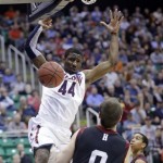 Arizona's Solomon Hill (44) dunks in front of Harvard's Laurent Rivard (0) in the first half during a third-round game in the NCAA men's college basketball tournament in Salt Lake City Saturday, March 23, 2013. (AP Photo/Rick Bowmer)
