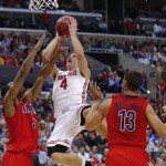 Ohio State's Aaron Craft (4) takes aim over Arizona defenders Kevin Parrom, left, and Nick Johnson during the first half of a West Regional semifinal in the NCAA men's college basketball tournament, Thursday, March 28, 2013, in Los Angeles. (AP Photo/Jae C. Hong)