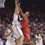 Arizona's Mark Lyons, right, goes up for a shot against UCLA's Travis Wear in the first half of a semifinal Pac-12 tournament NCAA college basketball game, Friday, March 15, 2013, in Las Vegas. (AP Photo/Julie Jacobson)