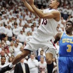 Arizona's Nick Johnson (13) shoots past UCLA's Jordan Adams (3) during the first half of an NCAA college basketball game in Tucson, Ariz., Thursday, Jan. 24, 2013. (AP Photo/John Miller)