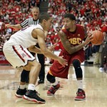 Southern California's J. T. Terrell, right, looks to pass the ball around Arizona's Nick Johnson during the first half of an NCAA college basketball game at McKale Center in Tucson, Ariz., Saturday, Jan. 26, 2013. (AP Photo/Wily Low)
