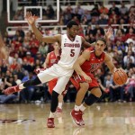 Arizona guard Nick Johnson, right, dribbles next to Stanford guard Chasson Randle (5) during the first half of an NCAA college basketball game on Wednesday, Jan. 29, 2014, in Stanford, Calif. (AP Photo/Marcio Jose Sanchez)