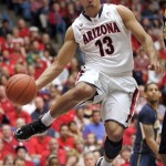 Arizona's Nick Johnson (13) looks to pass the ball under the basket during the first half against California of an NCAA college basketball game at McKale Center in Tucson, Ariz., Sunday, Feb. 10, 2013. (AP Photo/John Miller)
