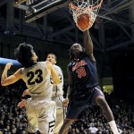 Arizona forward Angelo Chol (30) dunks as Colorado guards Sabatino Chen (23) and Andre Roberson defend in the first half of an NCAA college basketball game in Boulder, Colo., Thursday, Feb. 14, 2013. (AP Photo/David Zalubowski)