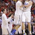 UCLA's Travis Wear, right, celebrates with teammates after beating Arizona 66-64 during a semifinal Pac-12 tournament NCAA college basketball game, Friday, March 15, 2013, in Las Vegas. (AP Photo/Julie Jacobson)