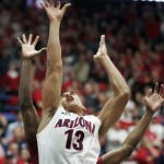 Arizona's Nick Johnson (13) shoots for two points despite the attempted defense by Washington States' Que Johnson, back, in the first half of an NCAA college basketball game on Thursday, Jan. 2, 2014, in Tucson, Ariz. (AP Photo/John MIller)