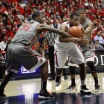 Washington State's D.J. Shelton (23) and Royce Woolridge, right, struggles with Arizona's Kevin Parrom, center, for control of the ball during the second half of an NCAA college basketball game at McKale Center in Tucson, Ariz., Saturday, Feb. 23, 2013. (AP Photo/Wily Low)

