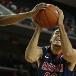 Arizona's Grant Jerrett has his shot blocked by Southern California's Renaldo Woolridge during the first half of an NCAA college basketball game in Los Angeles, Wednesday, Feb. 27, 2013. (AP Photo/Jae C. Hong)